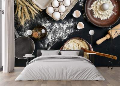 Female hands making/ mixing dough in brown bowl on black table, baking preparation close-up. Wall mural