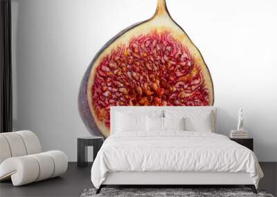 Half of a purple fig isolated on white background with copy space. Soft, sweet fruit, skin is thin, red flesh has many seeds inside of it. Close-up. Wall mural