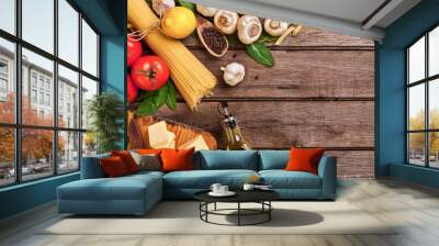 ingredients for spaghetti with basil, tomatoes, cheese on wooden background, top view, place for tex Wall mural