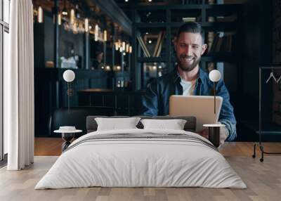 Modern hipster businessman drinking coffee in the city cafe during lunch time and working on tablet Wall mural