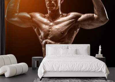 Muscular and fit young bodybuilder fitness male model posing ove Wall mural