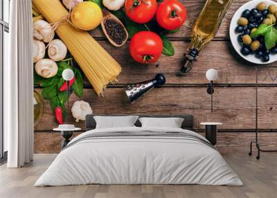 Pasta and ingredients on wooden background with copy space. Top view. Vegetarian food, healthy or cooking concept. Wall mural