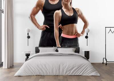 Sport, fitness, workout concept. Fit couple, strong muscular man and slim woman posing on a white background Wall mural