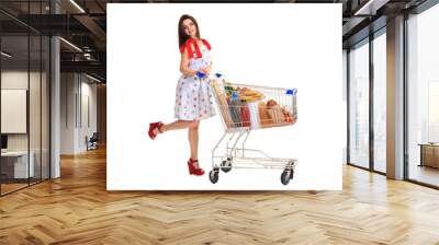 Young woman with full shopping cart on white background Wall mural