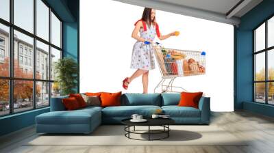 Young woman with full shopping cart on white background Wall mural