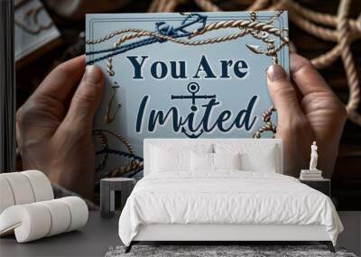 Close-up of hands presenting a nautical-themed invitation card with 