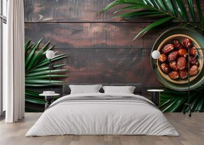 Top view of a bowl of dates on top of wooden table and green leaves ai generative Wall mural