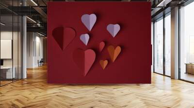 The image shows the red, pink and orange love symbols on a bright red background Wall mural