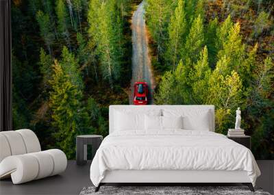 Aerial view of red car with a roof rack on a country road in Finland Wall mural