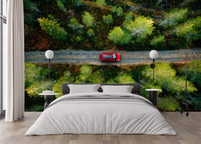 Aerial view of red car with a roof rack on a country road in Finland Wall mural