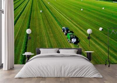 Aerial view of Tractor mowing green field in Finland. Wall mural