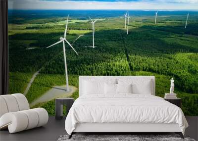 Aerial view of windmills in summer forest in Finland. Wind turbines for electric power with clean and Renewable Energy Wall mural