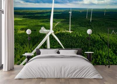 Aerial view of windmills in summer forest in Finland. Wind turbines for electric power with clean and Renewable Energy Wall mural