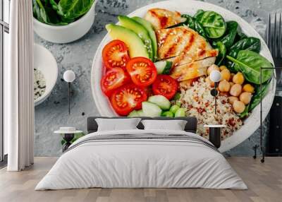 Buddha bowl with spinach salad, quinoa, chickpeas, grilled chicken, avocado, tomatoes, cucumbers, sesame seeds. Wall mural