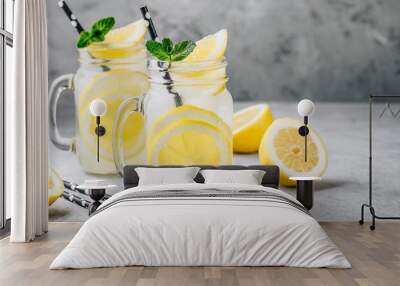 Homemade refreshing summer lemonade drink with lemon slices and ice in mason jars Wall mural