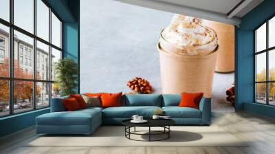 Pumpkin and carrot spice latte with whipped cream and cinnamon in glass jars Wall mural