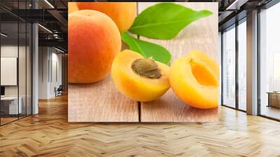 Ripe peaches and leaves on table Wall mural