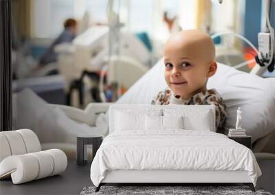 A portrait of a bald young patient boy smiling in a cancer hospital bed in a medical care hospice bald after course chemotherapy. Children with cancer concept Wall mural