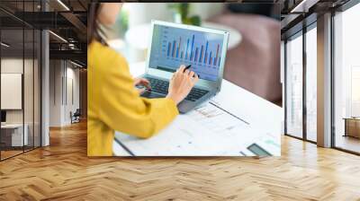 business woman using laptop or notebook computer with data analysis graph dashboard, confident woman working with computer laptop concept, contact idea design dashboard graph business conceptual. Wall mural