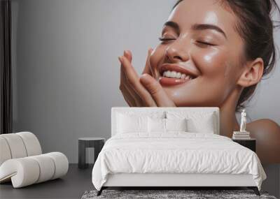 Skincare. Woman with beautiful face touching healthy facial skin. Woman smiling while touching her flawless glowy skin with copy space for your advertisement, skincare Wall mural