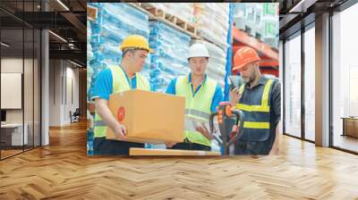 Warehouse workers in helmets checking goods and supplies on shelves with goods background in warehouse worker packing in a large warehouse in a large warehouse. Logistics industry concept.. Wall mural