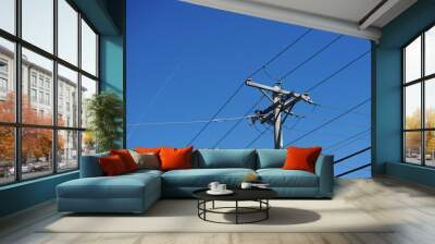 electricity pole against blue sky Wall mural