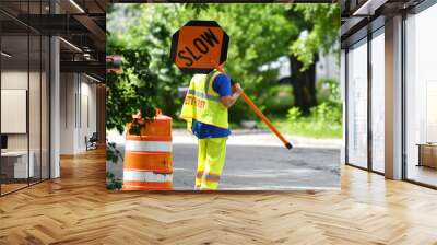 outdoor worker hold slow sign at road construction site Wall mural