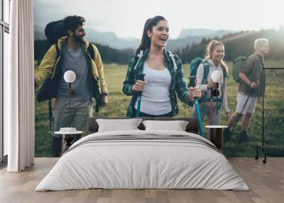 Adventure, travel, tourism, hike and people concept - group of smiling friends with backpacks and map outdoors Wall mural