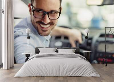 Attractive elegant happy man in good car Wall mural