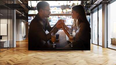 Attractive elegant young couple in love dating at the restaurant. Wall mural