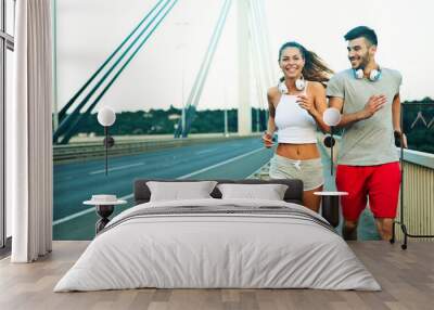 Attractive man and beautiful woman jogging together Wall mural