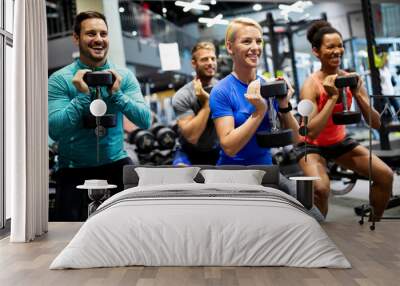 Attractive sports people friends are working out in gym Wall mural