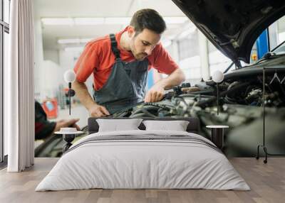 Auto mechanic working in garage. Repair service. Wall mural