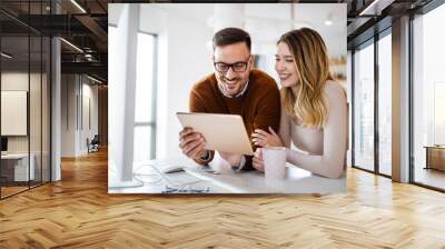 Beautiful couple working on a tablet at home Wall mural