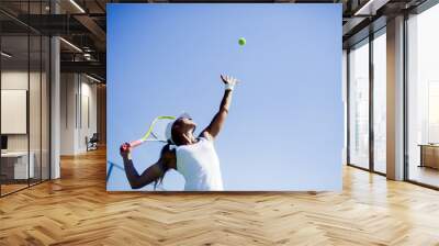 Beautiful female tennis player serving Wall mural