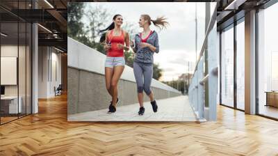 Beautiful scenery of two female joggers Wall mural