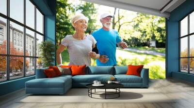 Beautiful sporty mature couple styaing fit with sport Wall mural