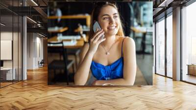 Beautiful woman talking on cell phone Wall mural