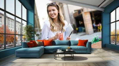 Beautiful young happy cheerful woman enjoying her time and freedom Wall mural