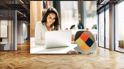 brunette using laptop in cafe Wall mural