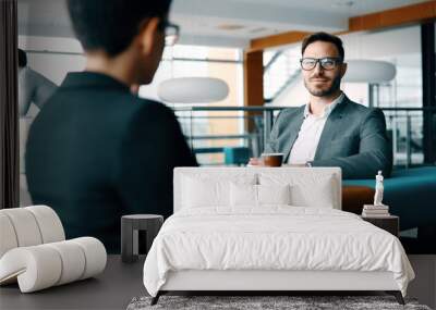 Business colleagues having conversation during coffee break Wall mural