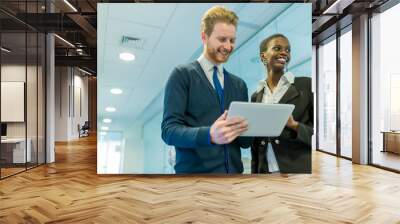 Business partners discussing ideas displayed on a tablet Wall mural