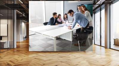 Business people having board meeting in modern office Wall mural