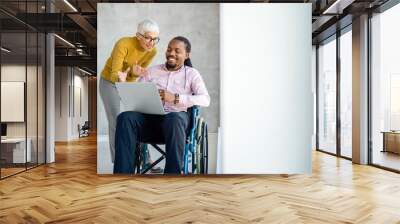 Business people with disability in wheelchair working together in office Wall mural