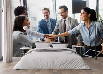 Business team celebrating a good job in the office Wall mural