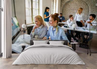 Business women entrepreneurs working in coworking space smiling, brainstorming as a team in office Wall mural