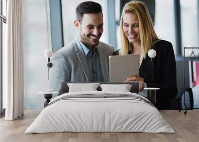 Businesspeople discussing while using digital tablet in office Wall mural