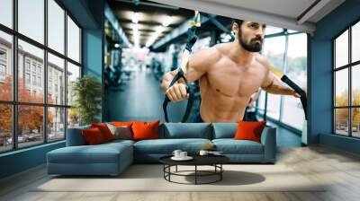 Caucasian man exercising suspension training trx Wall mural