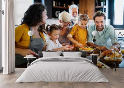 Cheerful family spending good time together while cooking in kitchen Wall mural