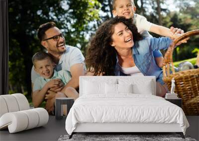 Cheerful happy family picnicking on a beautiful day Wall mural